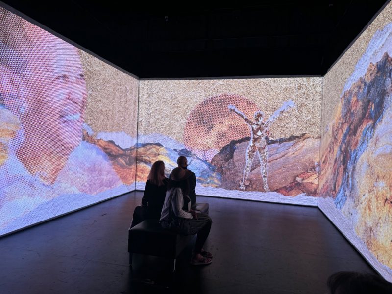 Three people experience the June iteration of the Nikki Giovanni immersive experience at the Cube at the Center for the Arts. Photo by Meaghan Dee for Virginia Tech.