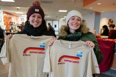 Students holding t-shirts for Virginia Tech's Giving Day. 