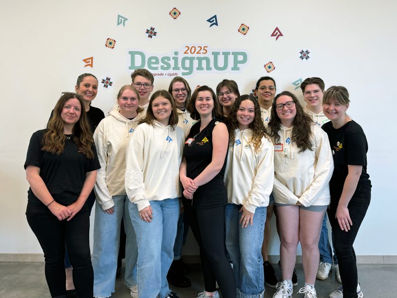 Group photo from DesignUP event of students and professors